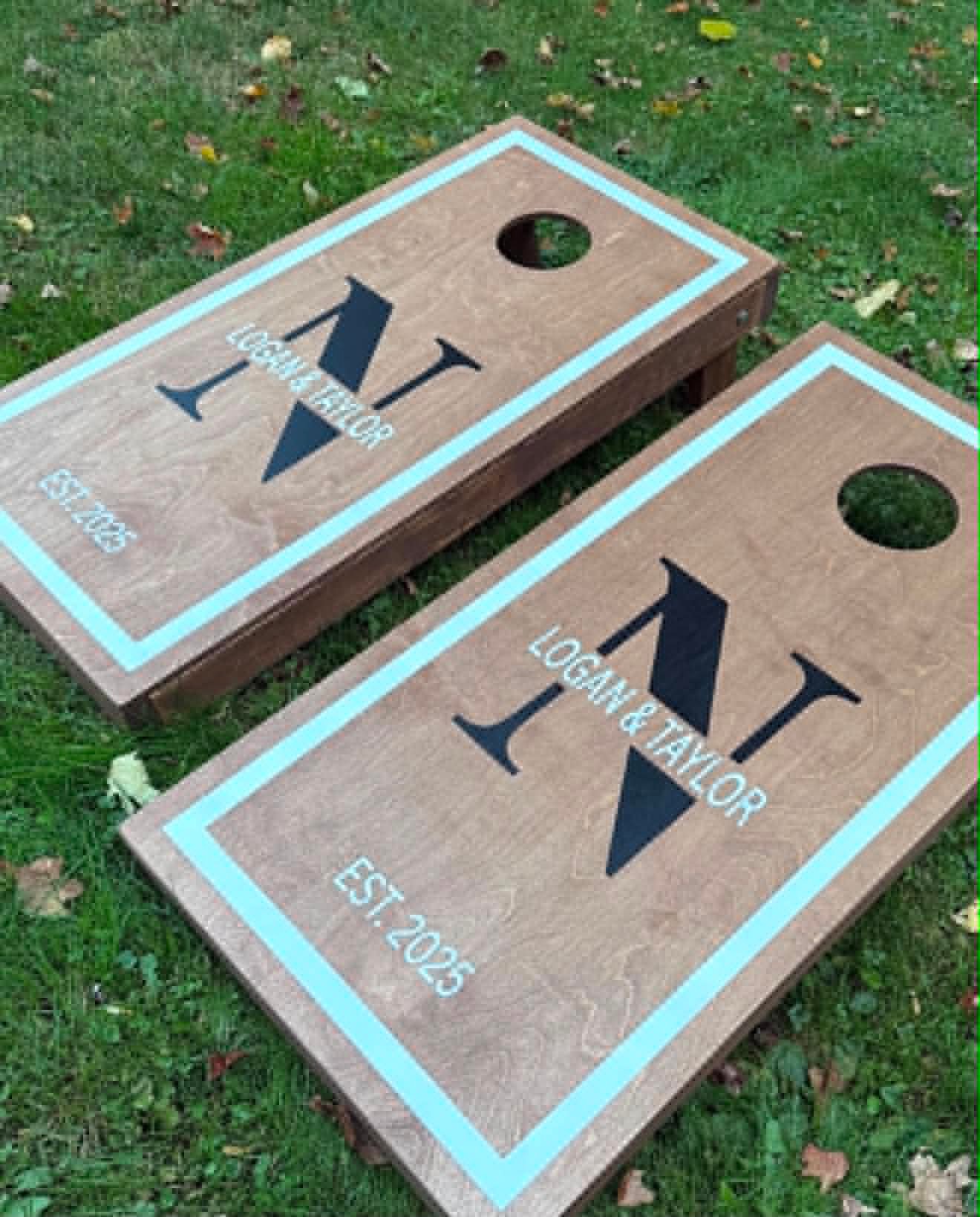 Custom cornhole board set with a monogram N and Logan & Taylor Est. 2025 lettering