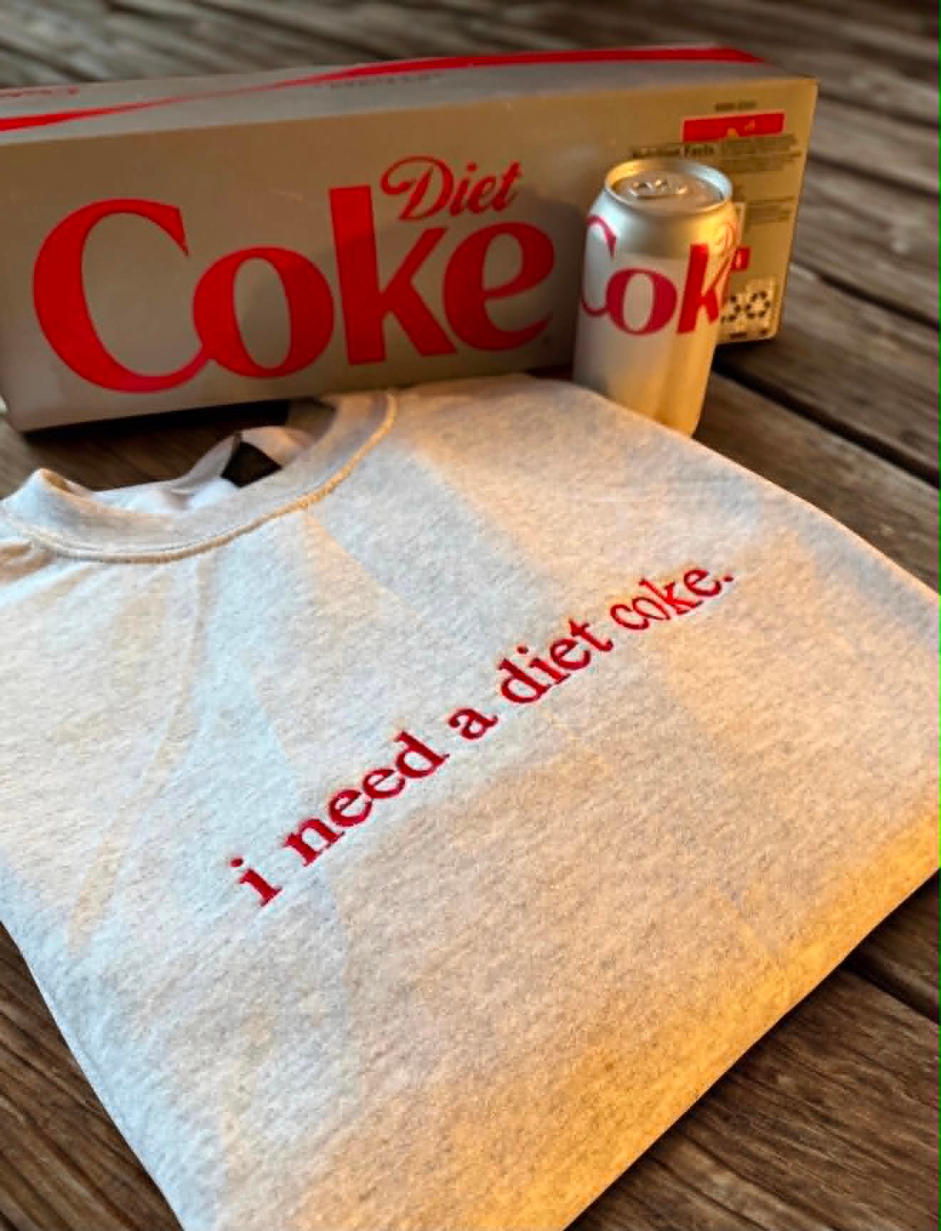 Heather grey Gildan crewneck embroidered in red script reading i need a diet coke